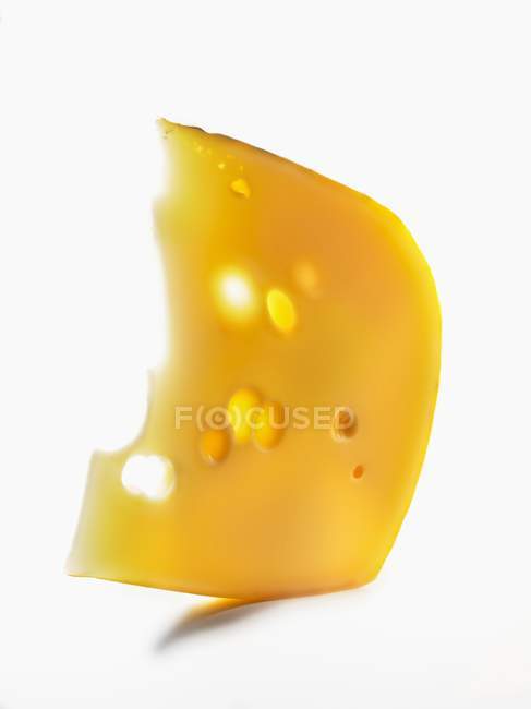 Wedge of cheese with holes — Stock Photo