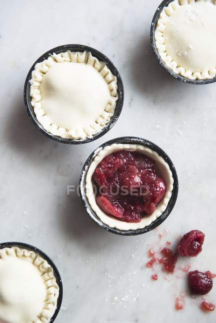 Top view of raw almond pies with cherry filling — Stock Photo