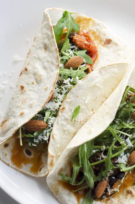Closeup view of Burritos filled with rocket and almonds — Stock Photo