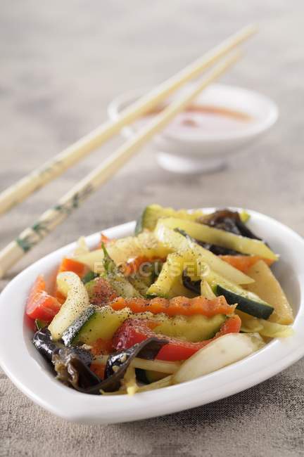 Chop Suey in a small bowl with chopsticks — Stock Photo