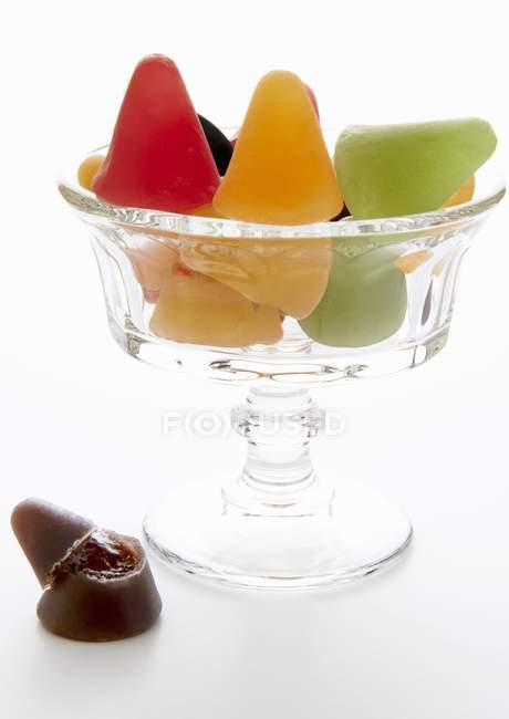Closeup view of whole and broken Cuberdons sweets in glass dish — Stock Photo