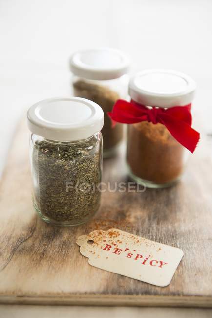 Closeup view of assorted spices in screw-top jars — Stock Photo