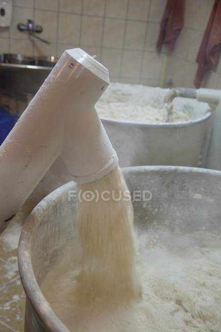 Machine pouring flour — Stock Photo