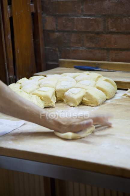 Hands shaping bread rolls — Stock Photo