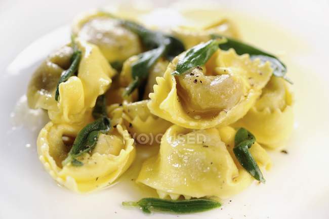 Tortelloni pasta in sage butter — Stock Photo