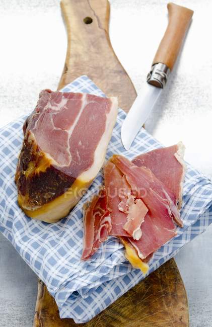 Partly sliced Spanish Serrano ham — Stock Photo