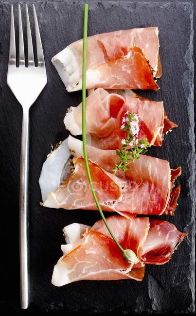 Black Forest ham with herbs — Stock Photo