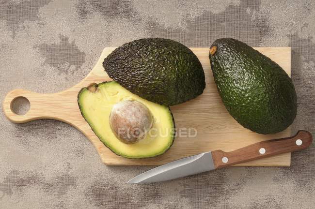 Fresh avocados with half — Stock Photo