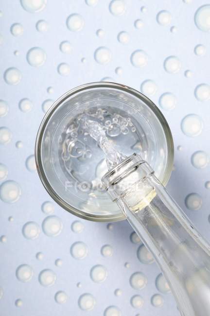 Pouring water into glass — Stock Photo