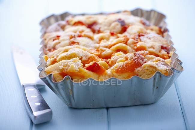 Apricot cake with knife — Stock Photo