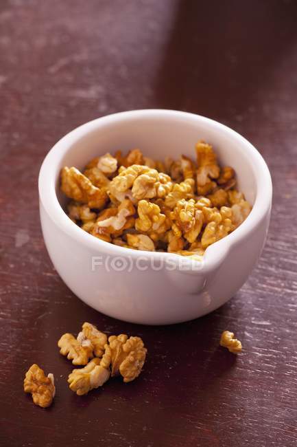 Shelled raw walnuts in mortar — Stock Photo