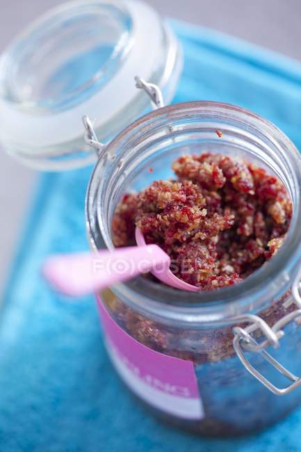 Closeup view of cranberry and lemon paste with spoon in jar — Stock Photo