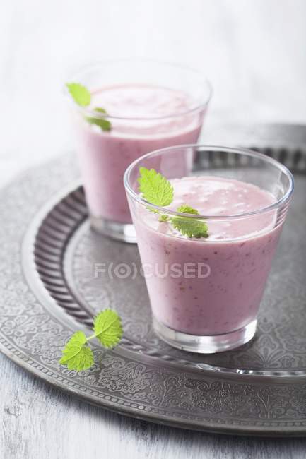 Raspberry milkshakes with lemon balm — Stock Photo