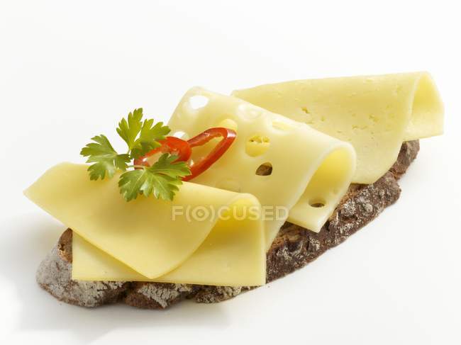 Slice of bread topped with cheese — Stock Photo