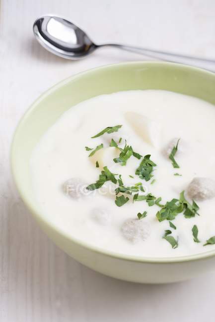 Cream of asparagus soup with meatballs in white bowl — Stock Photo
