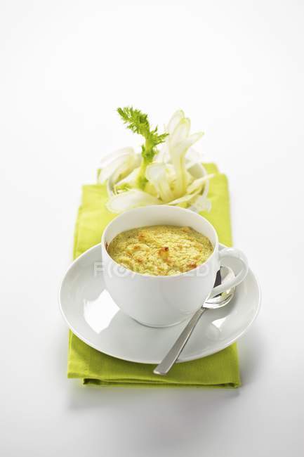 Fennel souffl in a cup over green towel on white surface — Stock Photo