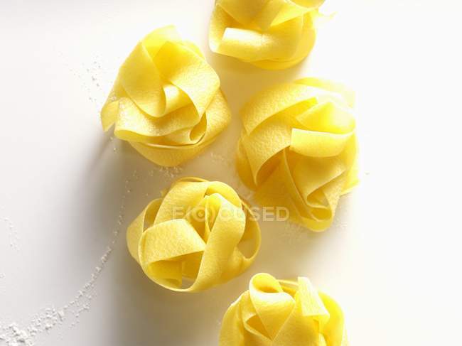 Homemade pappardelle pasta nests — Stock Photo