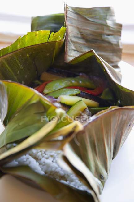 Rice and courgette in banana leaf — Stock Photo