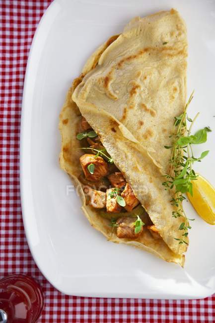 Pancake filled with fried cod — Stock Photo