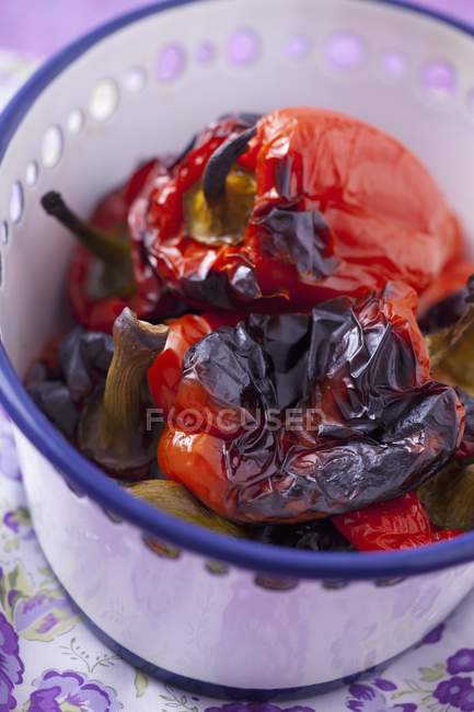 Baked peppers in white dish over cloth — Stock Photo
