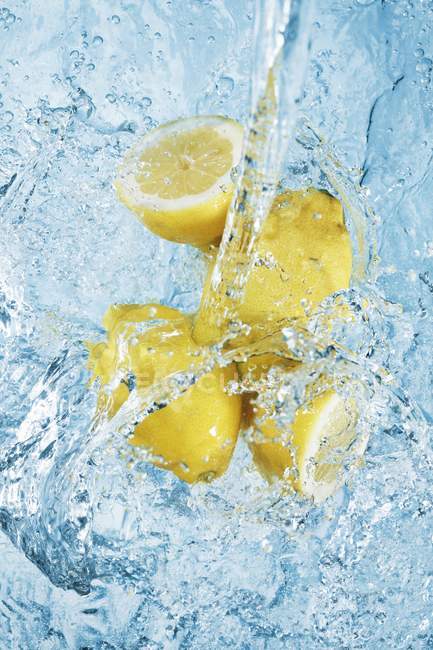 Fresh lemons in water — Stock Photo
