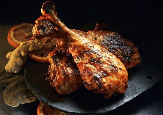 Closeup view of barbecued turkey legs with orange and ginger — Stock Photo