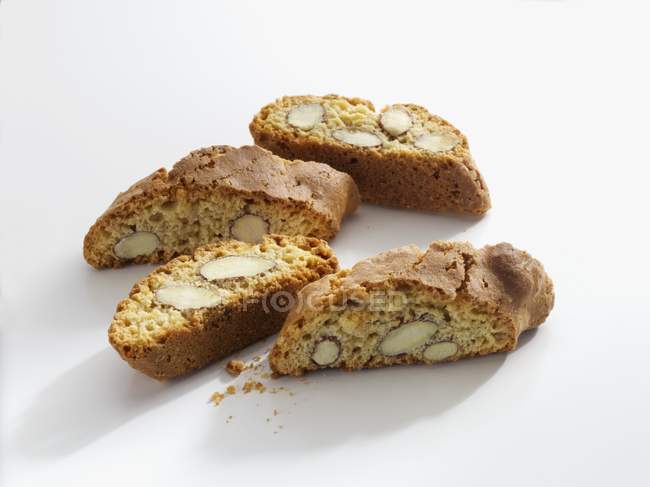 Closeup view of four Cantuccini slices on white surface — Stock Photo