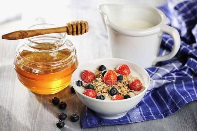 Muesli with berries and milk — Stock Photo
