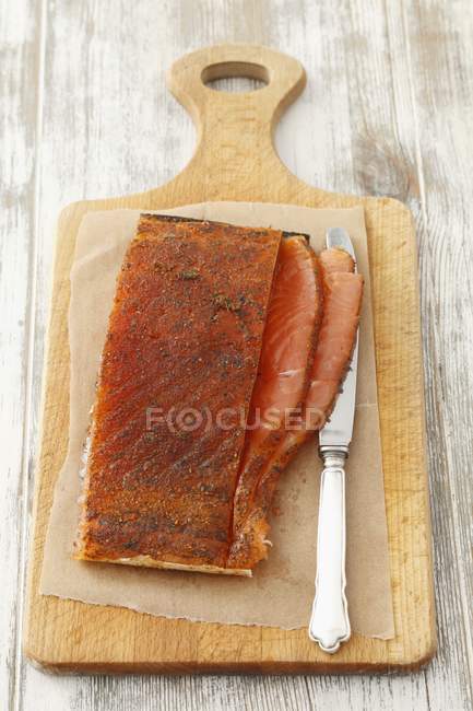 Smoked salmon on paper — Stock Photo