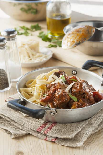 Stewed veal with fettuccine pasta — Stock Photo