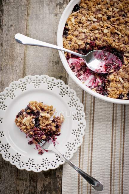 Top view of mixed berry crisp on a white plate with a fork — Stock Photo