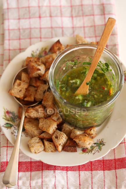 Elevated view of Gremolata sauce and croutons — Stock Photo