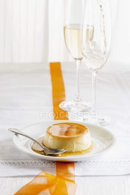 Closeup view of Creme caramel flan with spoon on plate — Stock Photo