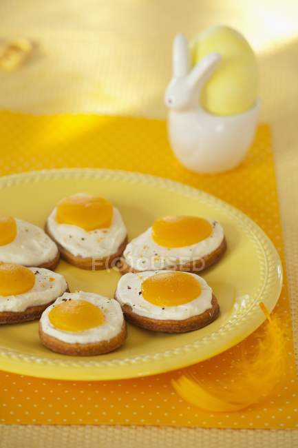 Closeup view of Easter butter biscuits topped with cream and apricot halves — Stock Photo