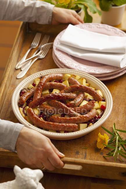 Sausages on fried potatoes — Stock Photo