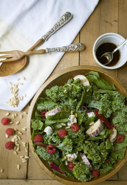 Top view of Lollo biondo lettuce with aubergines, raspberries and pine nuts — Stock Photo