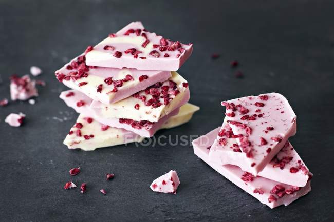 Chocolate with dried strawberry pieces — Stock Photo