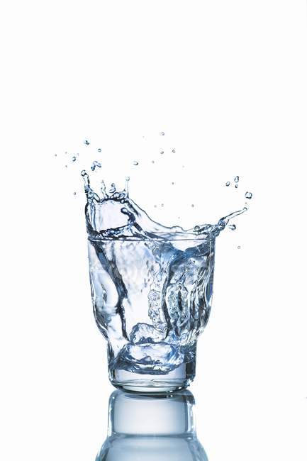 Closeup view of water glass with a splash — Stock Photo