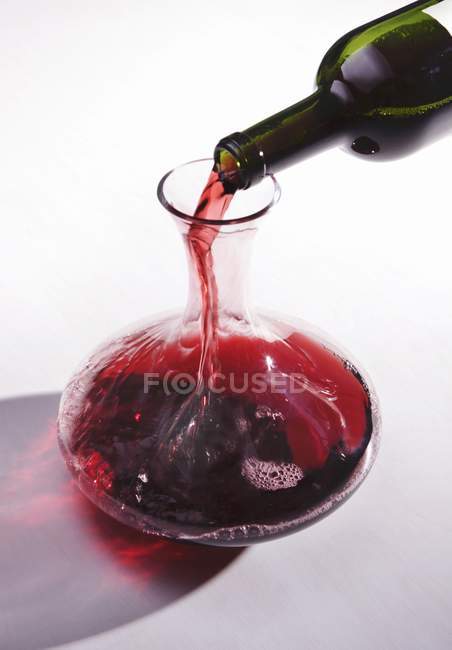 Red wine being decanted — Stock Photo