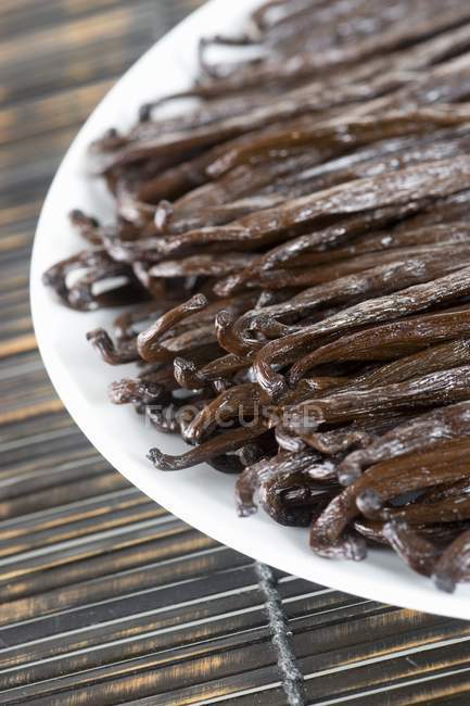 Dried Vanilla pods on plate — Stock Photo