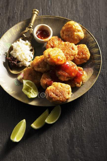Fischcakes with chilli and rice — Stock Photo