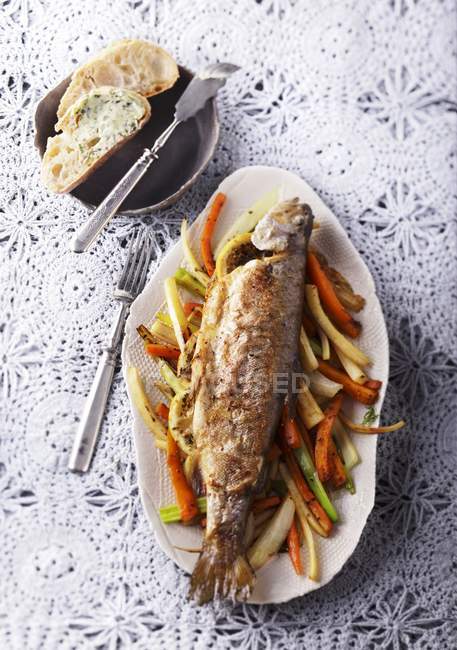 Trucha al horno en la cama de verduras - foto de stock