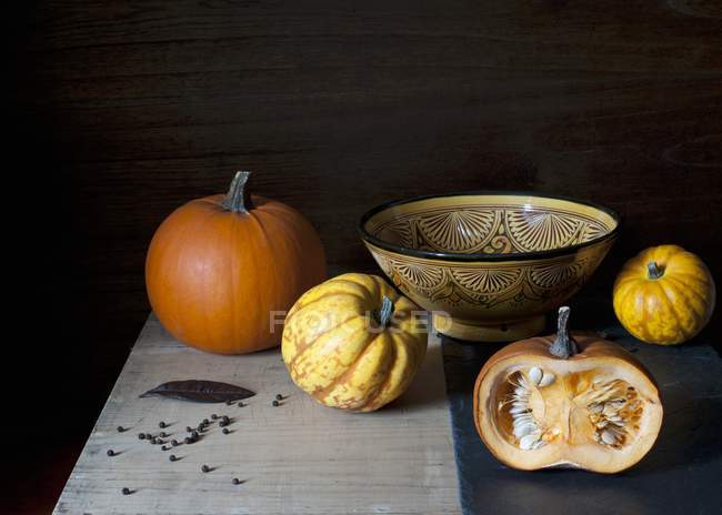 Fresh pumpkins with bowl — Stock Photo
