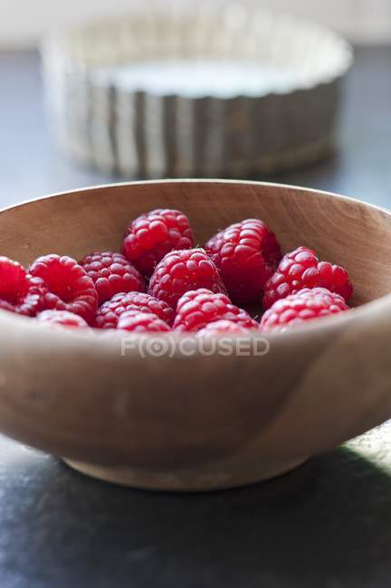 Raspberries in wooden bowl — Stock Photo