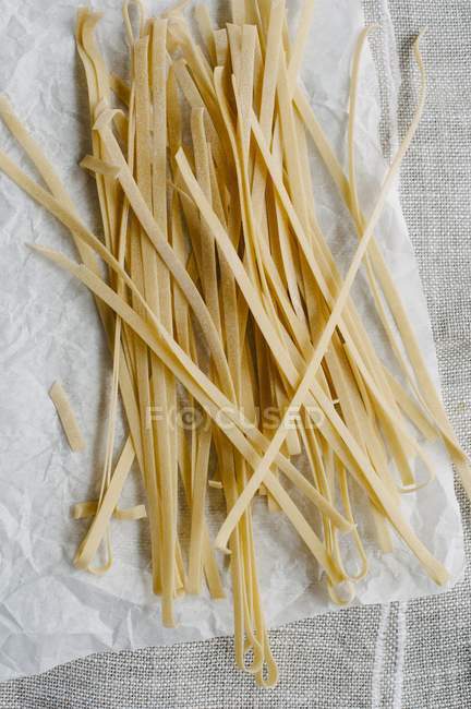 Raw tagliatelle pasta — Stock Photo