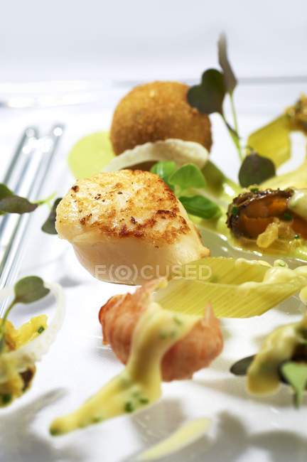 Fried scallops with celery on white surface — Stock Photo