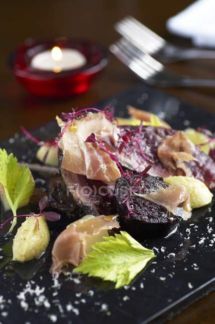 Hazel grouse with dry-cured ham — Stock Photo