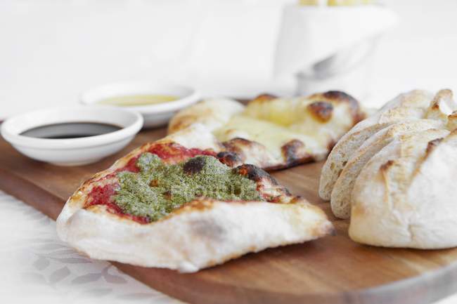 Assorted breads with pesto — Stock Photo