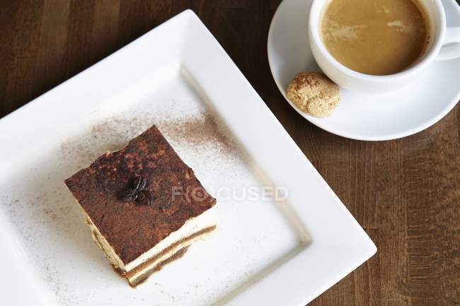 Tiramisu with coffee in cup — Stock Photo