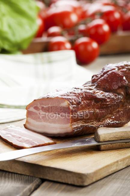 Partly sliced Speck ham — Stock Photo